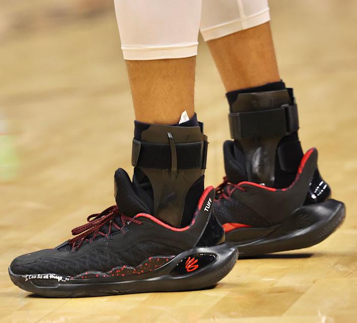 Golden State Warriors guard Stephen Curry's black and red Under Armour sneakers.